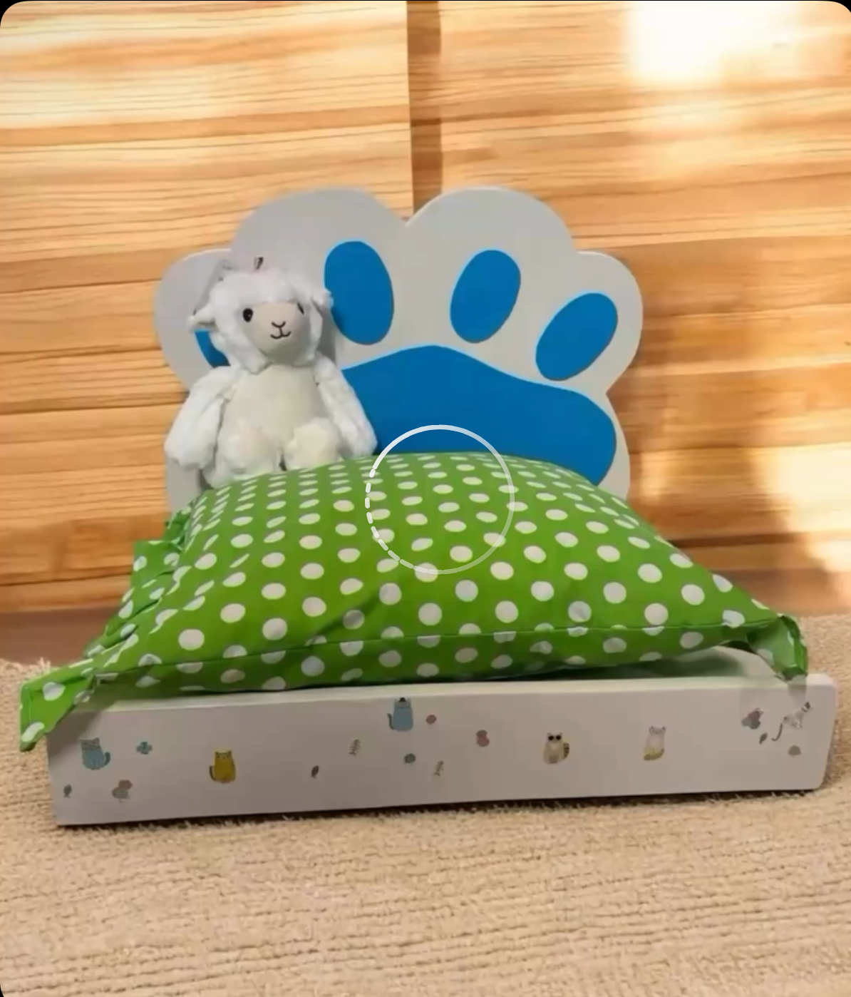 Cama artesanal de madera con cojín verde de lunares